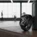 Jet Black Apple Watch Series 11 leaning against a black water bottle on a leather gym bench.