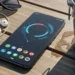 Black Google Pixel 9a laying flat showing a circular UI on the screen.