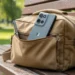 Motorola Moto G in a canvas field bag in a sunlit park.