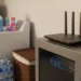 Aircove AX1800 VPN Wi-Fi Router on a professional rack cabinet in a residential laundry room.