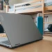 Gray Lenovo Yoga laptop on a student study desk with snacks and a water bottle.
