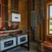 DIY off grid power system with inverter, lithium batteries and window view of solar panels in homestead shed