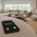 Smartphone showing a possible spam call on a coffee table in a bright living room